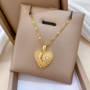 Detailed close-up of a gold-plated titanium double-layer broken heart necklace with crystals