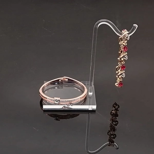Rose gold heart jewelry set with ruby zircon on transparent acrylic display stand