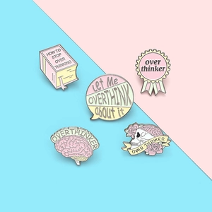 Pastel pink Overthinker enamel pin set with brain and skull designs for anxiety awareness