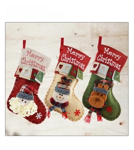 Detailed view of three Christmas stockings with 3D Santa, Snowman and Reindeer characters