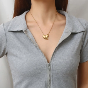 Minimalist 18K gold plated heart pendant necklace on model with grey polo shirt