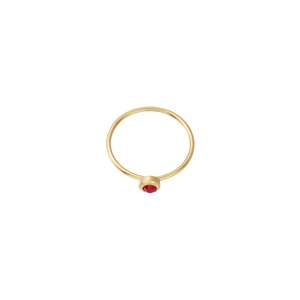 Close-up of minimalist gold ring featuring a bezel-set red birthstone on a slim band