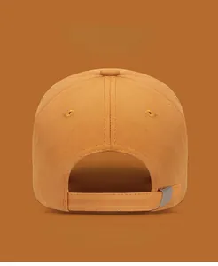 Detail of adjustable silver metal buckle and embroidery eyelets on yellow baseball cap