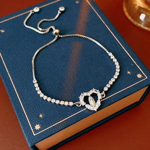 Detail of adjustable silver heart bracelet with Virgin Mary icon and zircon stones