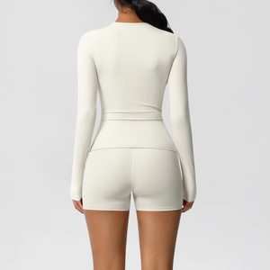 Detail view of the seamless high-waisted shorts and long sleeve top from the back