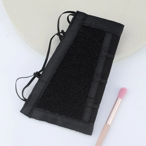 Professional black makeup brush cleaning arm band with elastic straps and Velcro
