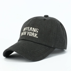 Macro view of high-quality black washed cotton baseball cap with white embroidery