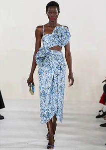 Detailed view of blue floral swimsuit with oversized 3D flower and waist cut-out detail