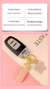Detailed view of pink leather keychain with alloy hook and delicate floral charm accessory