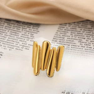 Detailed macro shot of 18K gold-plated liquid metal ring on vintage book pages
