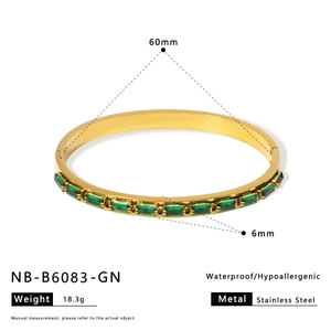 Detailed view of gold stainless steel bangle with emerald green zircon and dimensions