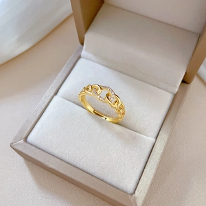Luxurious gold chain ring with pavé diamonds in a jewelry box, 45-degree angle view