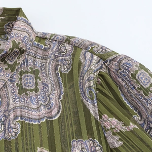 Detail of olive paisley print blouse with metallic threads and pleated cuff design