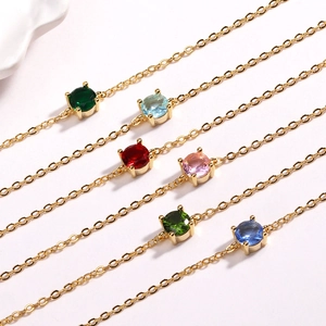 Close-up of vibrant gemstone bracelets in diverse colors with delicate gold plated chains