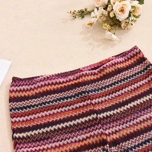 Detail of colorful wavy knit texture in purple and orange on this two-piece skirt set