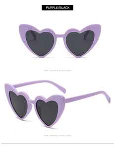 Detail view of heart-shaped sunglasses in matte purple with dark black lenses