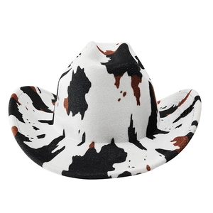 Detail of wide brim western cowboy hat with classic black and white cow print pattern
