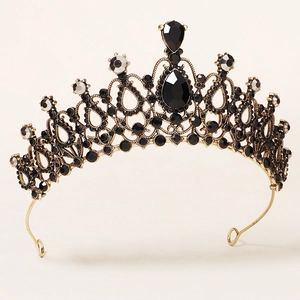 Detailed macro shot of vintage gold alloy crown with intricate black crystal inlays