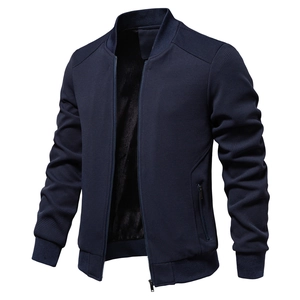 Detail of navy blue bomber jacket showing honeycomb textured fabric and ribbed cuffs