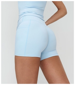 Detail of high-waisted yoga shorts in light blue with reinforced side stitching for lifting