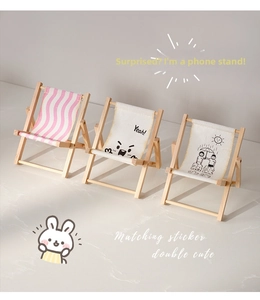 Detailed view of three foldable mini beach chair phone stands with cute graphic designs