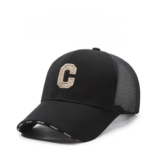 Detail of black mesh baseball cap featuring a large 3D embroidered C and Sport brim text