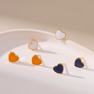 Elegant heart earrings in white orange and blue enamel with 18K gold plating set on ceramic