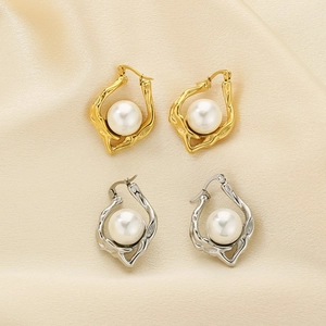 Irregular hammered gold and silver hollow hoop earrings with pearl on champagne satin
