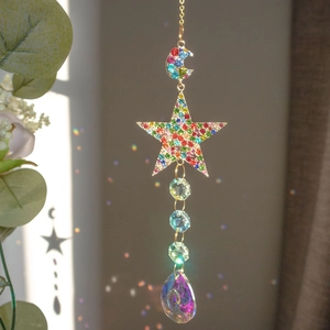 Detail of moon star crystal suncatcher with multi-faceted beads reflecting rainbows