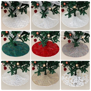 Various Christmas tree skirts with gold foil snowflakes and sequins in multiple colors