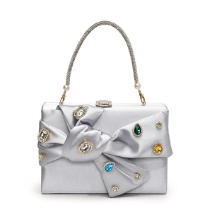 Elegant silver satin evening clutch bag with rhinestone bow and colorful gemstones