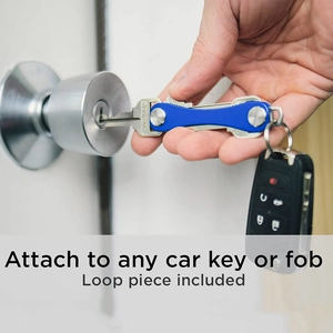 Blue metal key organizer shown inserting into a lock with an attached car key fob