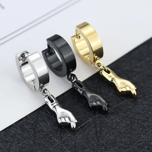 Detailed close-up of titanium steel huggie earrings with unique hand-shaped pendants