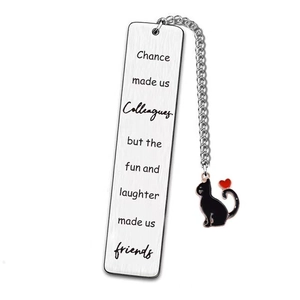 Macro shot of stainless steel bookmark with engraved text and cat heart pendant detail