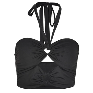 Detailed view of black halter crop top with crossover straps and open back cutout