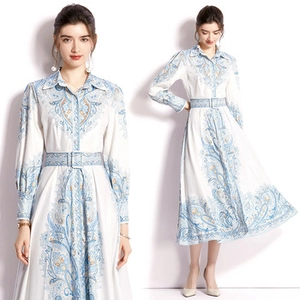 Detail of long sleeve ethnic print dress with blue patterns and a matching waist belt