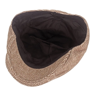 Macro view of herringbone newsboy cap interior featuring cotton lining and sweatband
