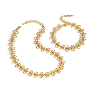 Gold butterfly chain necklace and bracelet set with infinity links on white background