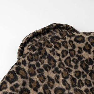 Detailed macro view of the premium leopard print faux fur fabric and plush texture