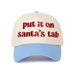 Close-up of red 'put it on santa's tab' embroidery on contrast panel baseball cap
