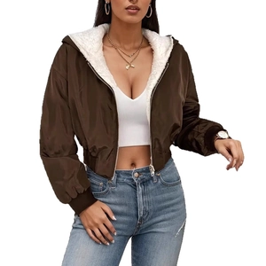 Detail of a brown hooded jacket with white faux shearling lining and metal zipper