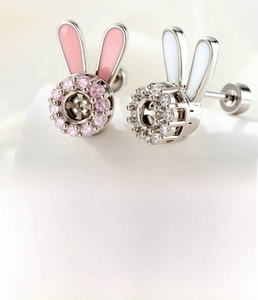 Macro detail of rotating bunny ear studs with 4mm zircon and titanium steel screw backs