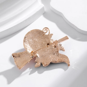 Back view of gold-tone Halloween witch broom brooch with secure pin clasp detail