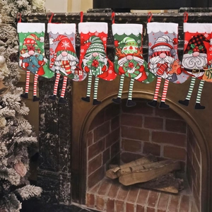 Set of 6 Christmas gnome stockings hanging on a fireplace for festive holiday home decoration