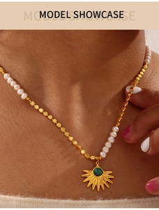 Close-up of freshwater pearl and gold bead necklace with sunburst turquoise pendant
