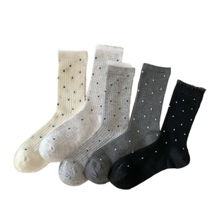 Five pairs of bamboo fiber crew socks with polka dot patterns and vertical ribs in grey tones
