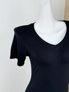 Detailed close-up of V-neckline and stitching on a black short-sleeve slim fit T-shirt