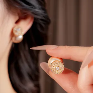 French vintage gold-plated pearl earrings with sparkling zircon accents on model
