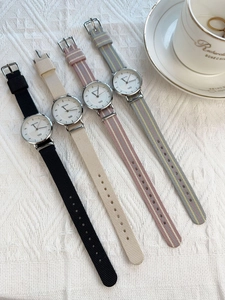 Detailed close-up of nylon watch straps in diverse colors with silver metal quartz cases