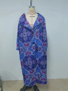 Detailed view of women's long coat with exotic mandala floral patterns and double buttons